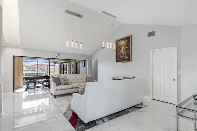 living room with high vaulted ceiling