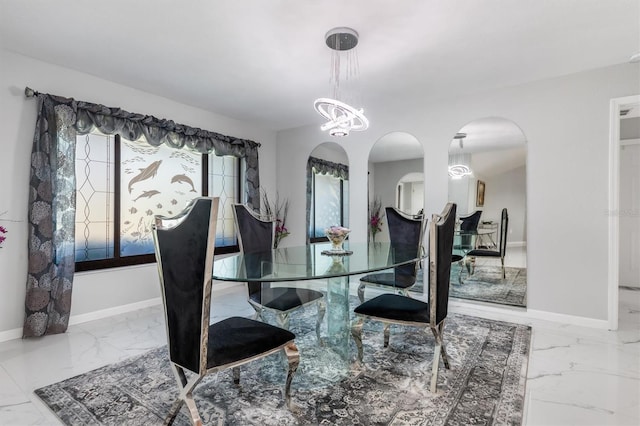 dining area with an inviting chandelier and a healthy amount of sunlight