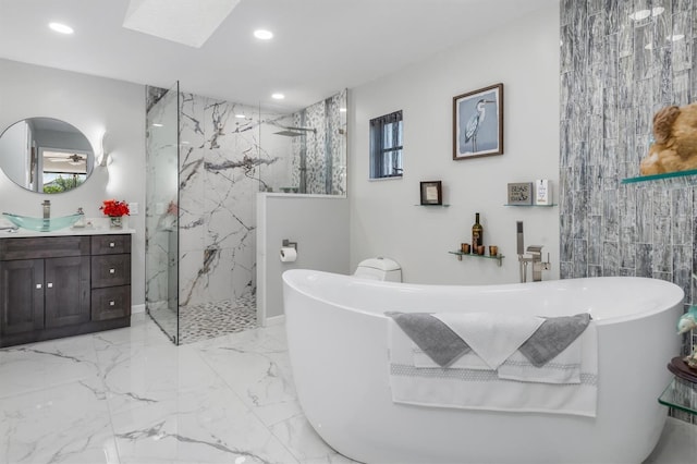 bathroom with vanity, shower with separate bathtub, and tile walls