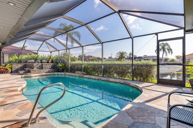 view of swimming pool featuring glass enclosure and a patio