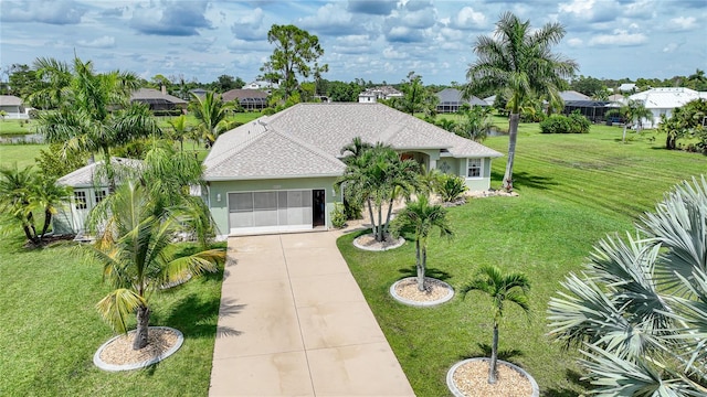 exterior space featuring a front lawn, stucco siding, a garage, and concrete driveway