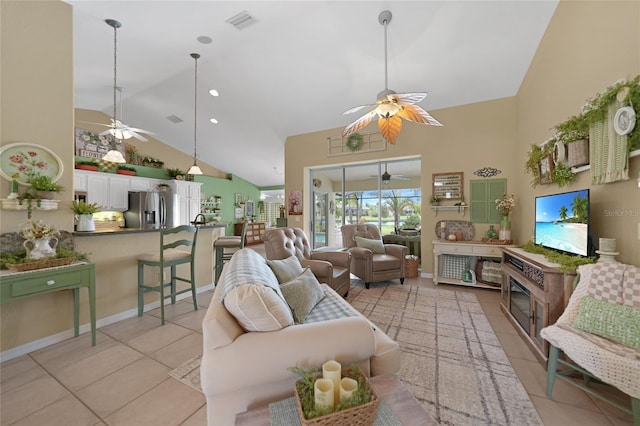 living area featuring light tile patterned flooring, high vaulted ceiling, visible vents, baseboards, and a ceiling fan