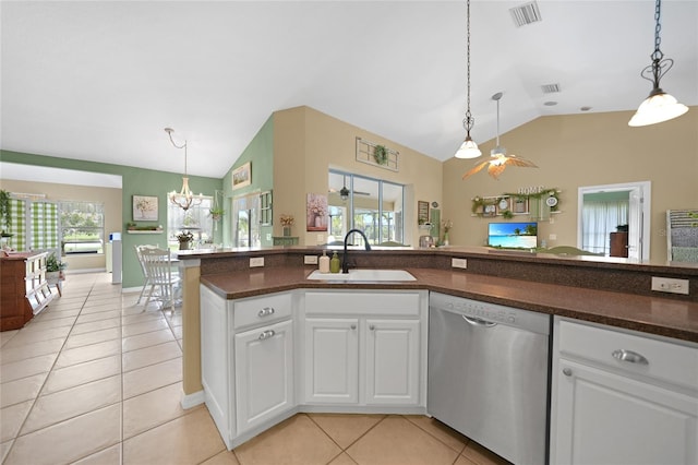 kitchen with lofted ceiling, light tile patterned floors, stainless steel dishwasher, a sink, and visible vents