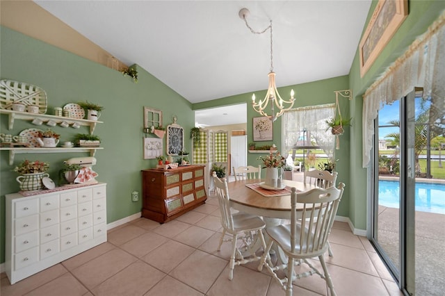dining area featuring light tile patterned floors, baseboards, lofted ceiling, and a chandelier