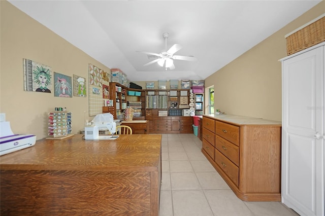 home office with a ceiling fan and light tile patterned flooring