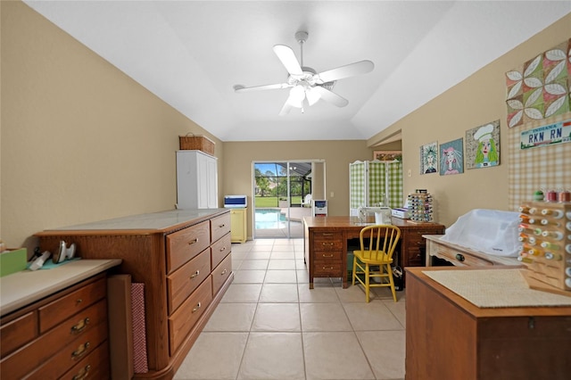 office featuring light tile patterned floors, vaulted ceiling, and a ceiling fan