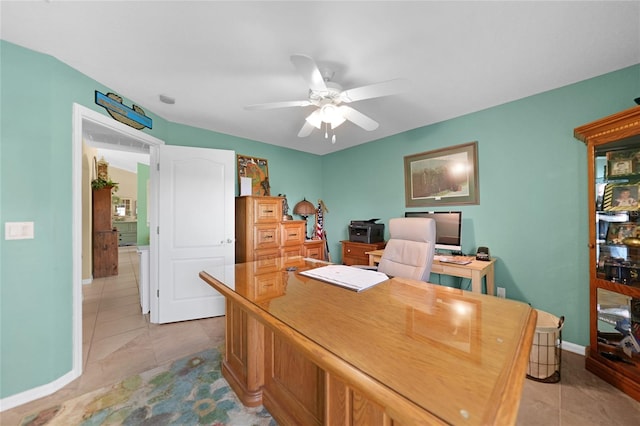 office space featuring baseboards, light tile patterned flooring, and a ceiling fan