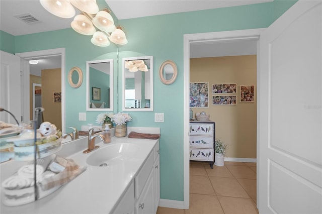 bathroom with baseboards, visible vents, tile patterned flooring, and vanity