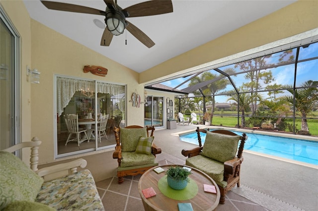 sunroom / solarium featuring vaulted ceiling, ceiling fan, and a swimming pool