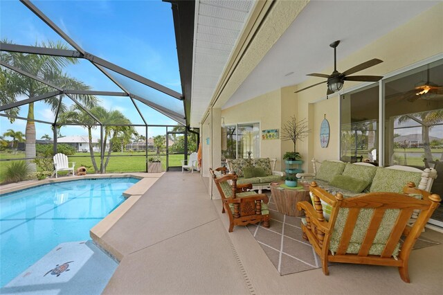 view of pool with a lanai, an outdoor hangout area, ceiling fan, and a patio area