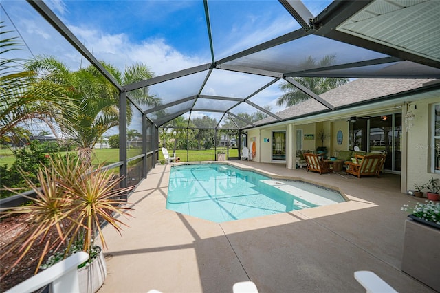 view of swimming pool with a patio, a lawn, ceiling fan, and glass enclosure