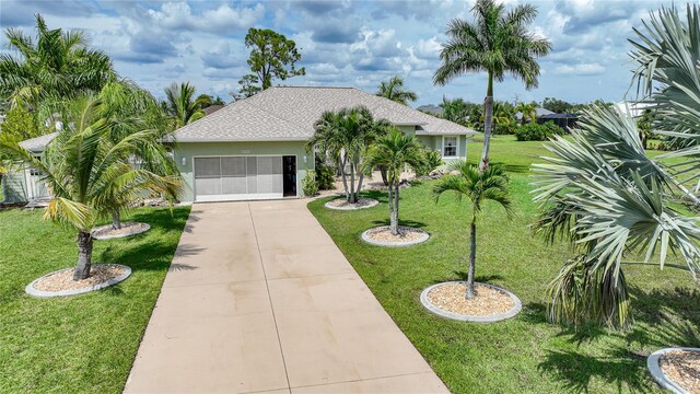 view of front of home with a garage and a front yard