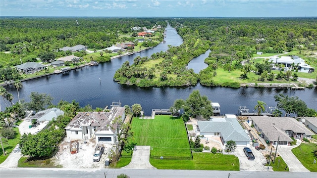 aerial view featuring a water view, a residential view, and a forest view