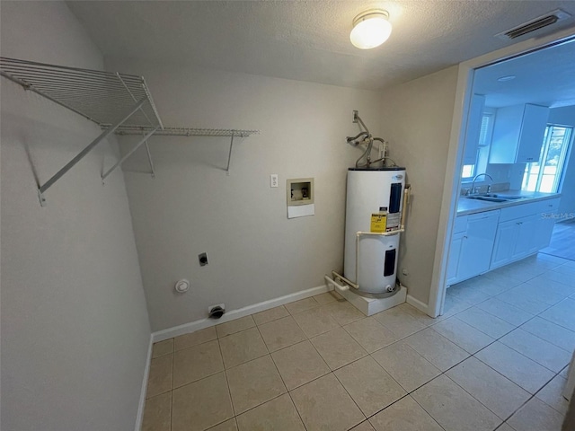 laundry room with electric dryer hookup, sink, hookup for a washing machine, water heater, and light tile patterned flooring