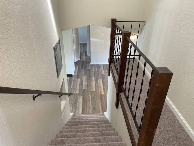 stairs with wood-type flooring