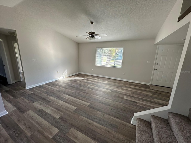 unfurnished living room featuring a textured ceiling, lofted ceiling, ceiling fan, and dark hardwood / wood-style floors