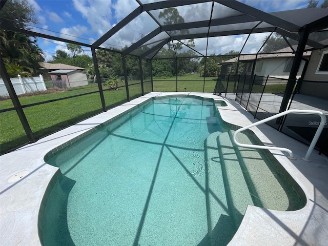 view of swimming pool with a patio, a lanai, and a lawn