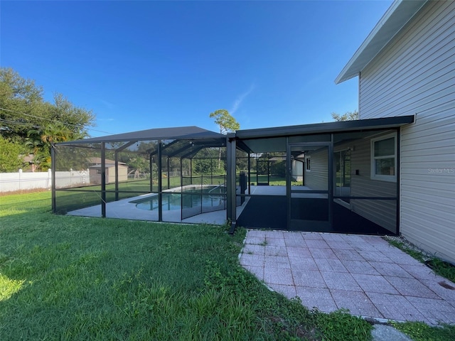 exterior space featuring a sunroom, glass enclosure, a patio area, and a fenced in pool