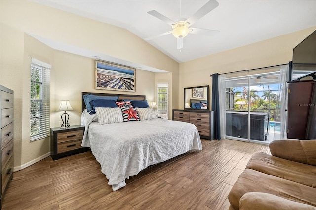 bedroom with multiple windows, access to outside, and hardwood / wood-style flooring