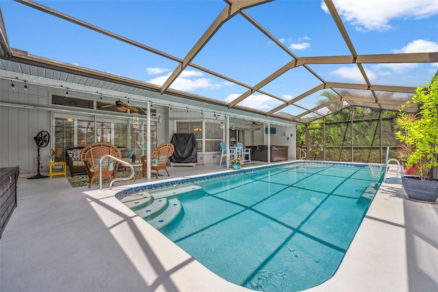 view of swimming pool with glass enclosure, ceiling fan, and a patio area