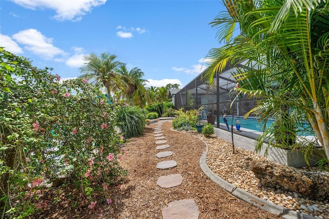 view of yard featuring glass enclosure