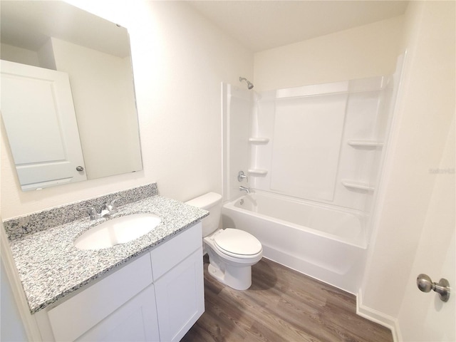 full bathroom featuring hardwood / wood-style floors, vanity, toilet, and shower / washtub combination