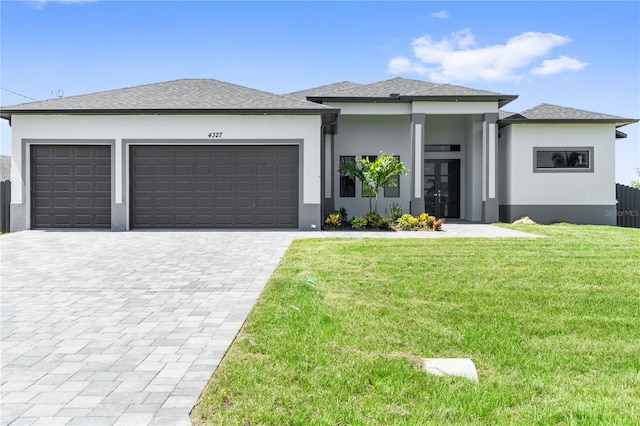 prairie-style house with a garage and a front lawn