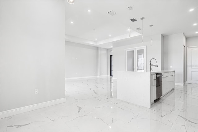 kitchen featuring an island with sink, stainless steel dishwasher, sink, and hanging light fixtures