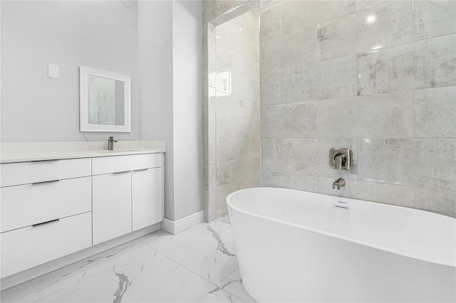 bathroom featuring a tub to relax in and vanity