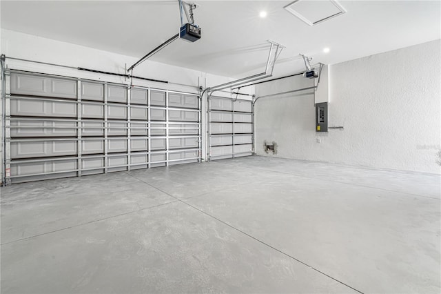 garage with a garage door opener and electric panel