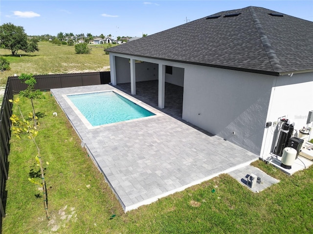 view of swimming pool with a yard and a patio