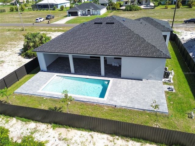 view of swimming pool featuring a yard and a patio