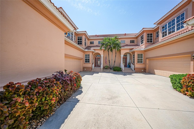 3959 San Rocco Ct Unit 911, Punta Gorda, FL 33950 - doorway to property with stucco siding, a garage, concrete driveway, and a tiled roof