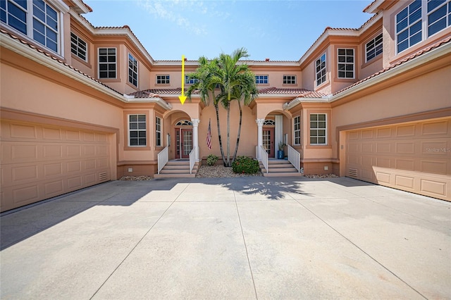 mediterranean / spanish house with a garage