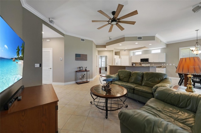 tiled living room with ceiling fan and ornamental molding