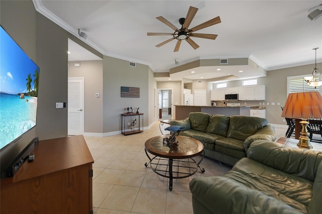 3959 San Rocco Ct Unit 911, Punta Gorda, FL 33950 - living room featuring crown molding, a ceiling fan, light tile patterned floors, baseboards, and healthy amount of natural light