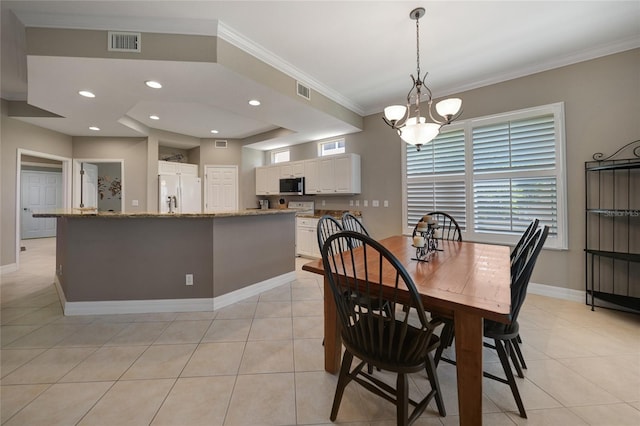 dining space with light tile patterned flooring, a chandelier, and crown molding