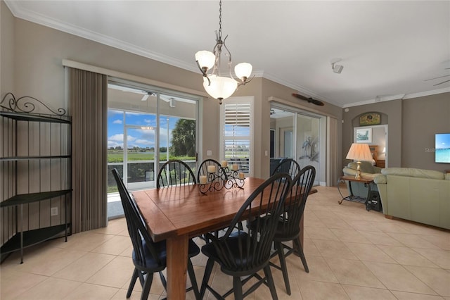 tiled dining room featuring ceiling fan with notable chandelier and ornamental molding