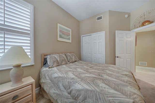 tiled bedroom featuring multiple windows and a closet