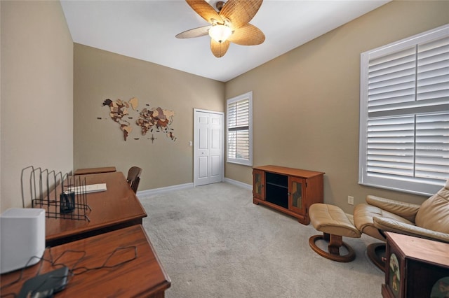 carpeted office space with ceiling fan