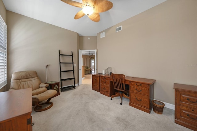 office featuring a wealth of natural light, ceiling fan, and light colored carpet