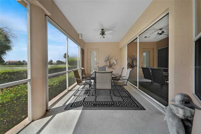 sunroom / solarium featuring ceiling fan