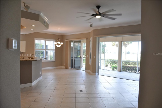 interior space with ceiling fan with notable chandelier, light tile patterned floors, and crown molding