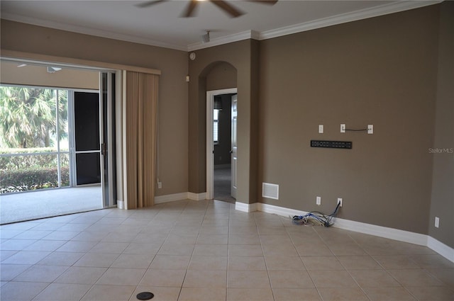 spare room featuring light tile patterned flooring, ceiling fan, a healthy amount of sunlight, and ornamental molding