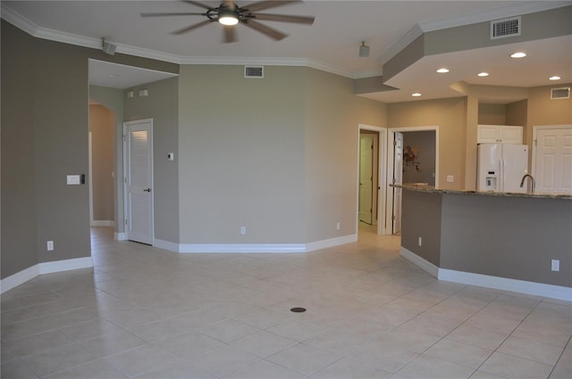 tiled spare room with ceiling fan and crown molding