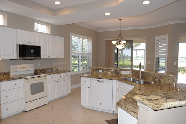 kitchen with white cabinets, white appliances, stone counters, and sink