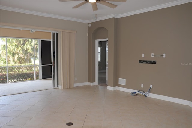 spare room featuring light tile patterned flooring, crown molding, ceiling fan, and plenty of natural light