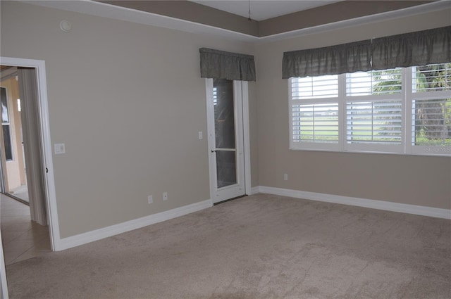 unfurnished room featuring light colored carpet