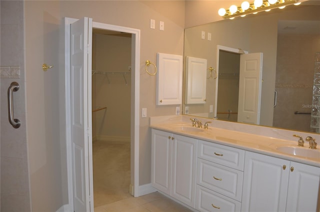 bathroom featuring vanity, tile patterned flooring, and a shower with door