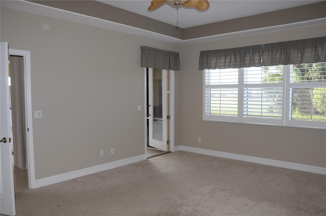 unfurnished room featuring light carpet and ceiling fan